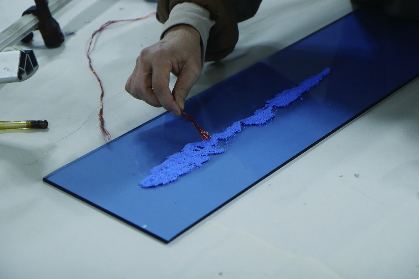 Lee Hyun-sook at work — drawing in glass with copper wire